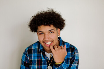 Teen pulls down lip to show gold teeth