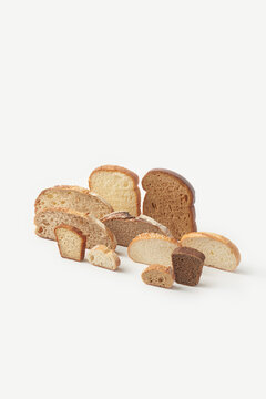 Slices of various types of bread arranged on grey background