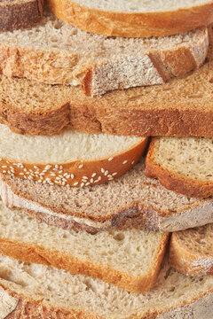 Stack of crusty slices of freshly baked various bread