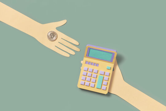 Papermade male hands holding bitcoins and calculator