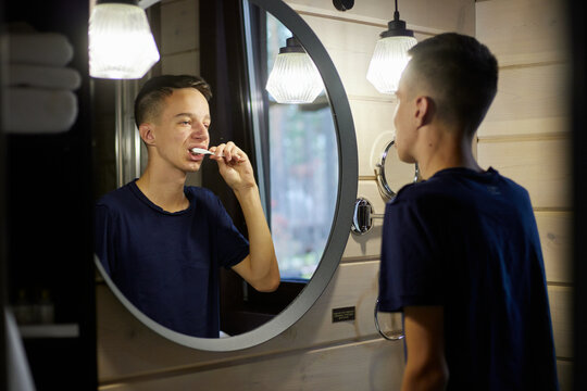 Teenager brushing his teeth 