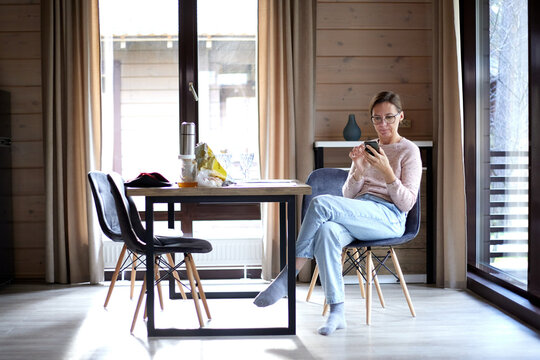 Woman in the living room  flips through the screen 
