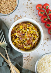 Mujadara- lentils and rice pilaf with fried onions on light background, vertical