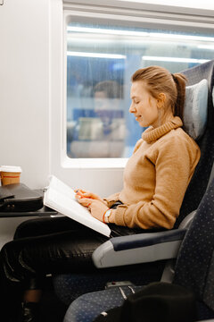 Young stylish girl traveling by train