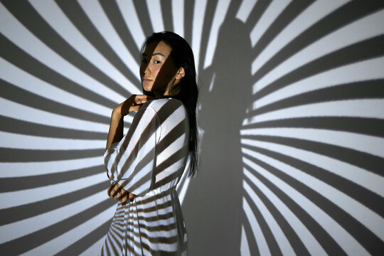 Portrait of a woman in the beams of a projector