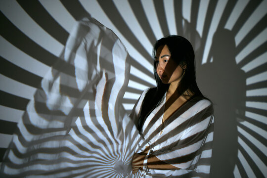 Portrait of a woman in the beams of a projector
