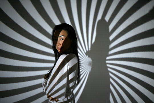 Portrait of a woman in the beams of a projector