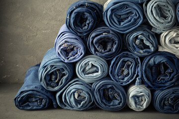 Blue jeans denim heap background. Jeans fabric stack as material surface