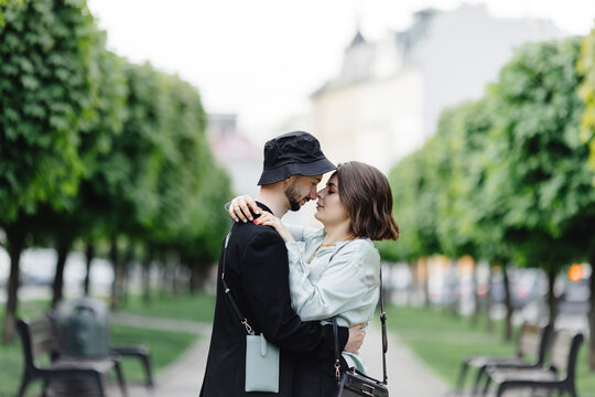 Romantic couple standing and embracing on alley