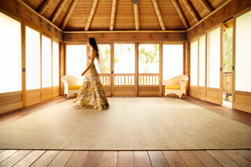 Architecture image of woman walking through Japanese screened in porch