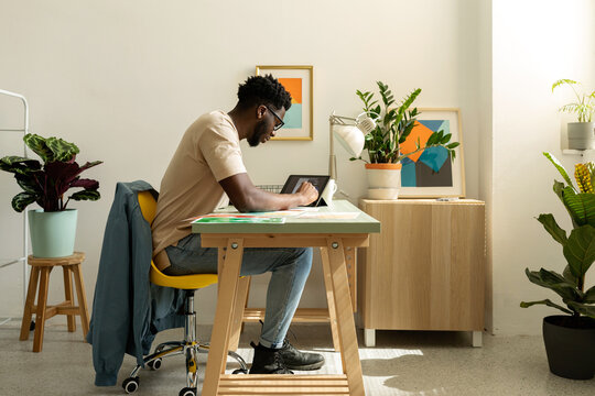African Man working with tablet at cool office