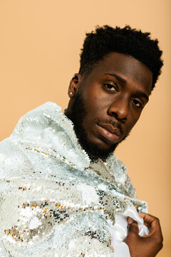 Stylish black man studio portrait with sequin jacket