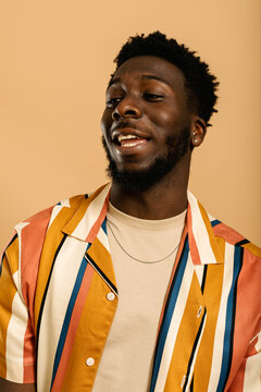 Positive black man in summer mode studio portrait