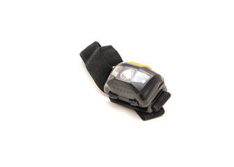 Elastic band and black headlamp with white LED bulb isolated on white background