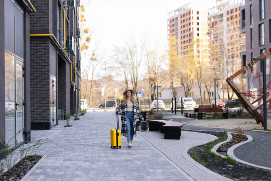 Female tourist bringing baggage to travel 