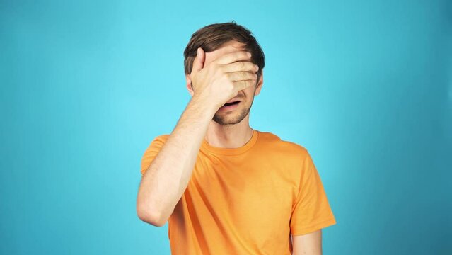 Face palm concept. Stressed out young guy making facepalm gesture with hand.