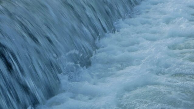 Forest waterfall in winter. waterfall channel in town. Drainage channel of treatment facilities. High quality FullHD footage High quality FullHD footage