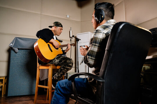 Two men making music in studio