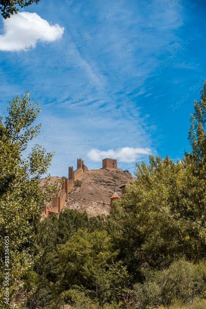 Wall mural castle and wall of albarracin, historic spanish village that overlooks the trees