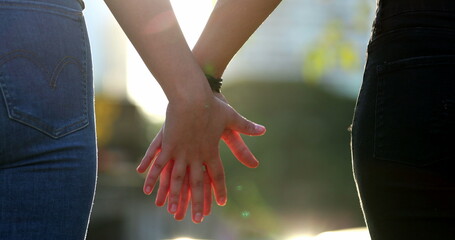 Joining hands together, uniting the chain from hands held together in the sunlight