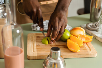 Waiter hands cutting citrus to make drinks