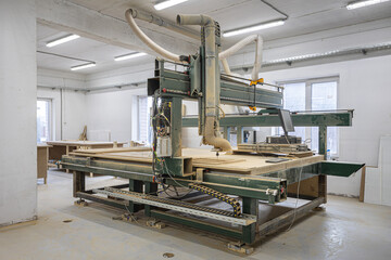 Industrial machine creating a wooden element for kraft furniture