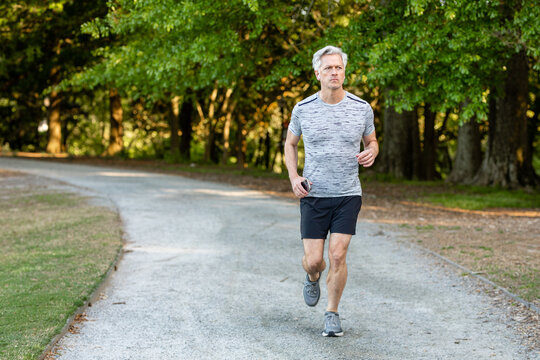 Older Gentlemen Jogs In The Park