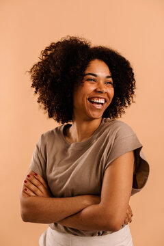 Lively woman with afro curly hair studio portrait