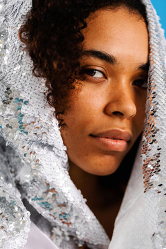 Staring woman covered with sequin cloth