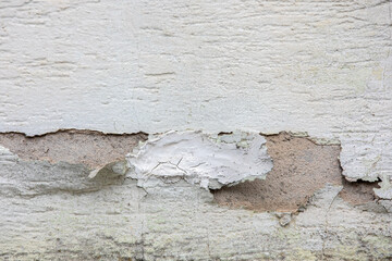 Exterior stucco on an old house is damaged. Exterior finish.