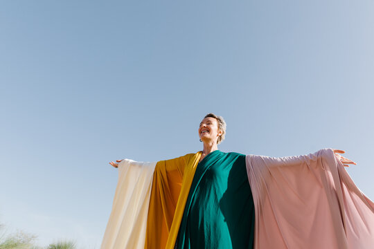  A woman with colourful pieces of fabric outdoors