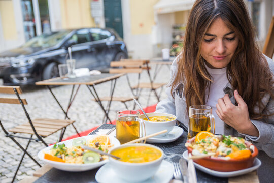 Woman enjoying meal on a terrace outdoors