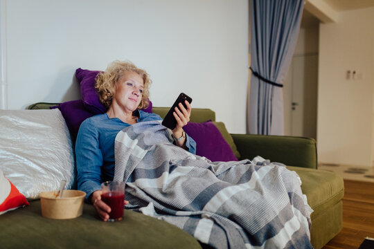 Woman at home using mobile phone