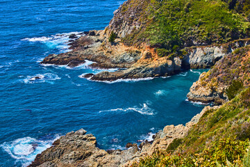 West coast cove on ocean with vibrant blue water
