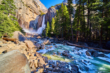 Yosemite Lower Falls in early morning with frosted rocks and ice cold river