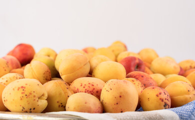 Ripe apricots on white background