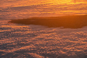 Mountain top Neighborhood looking over low clouds at sunrise in Southern California