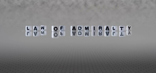 law of admiralty word or concept represented by black and white letter cubes on a grey horizon...