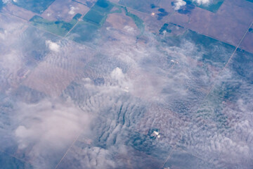 Aerial view of the midwest United States featuring farms in Minnesota as seen through clouds