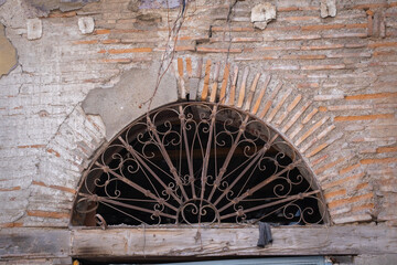 rusty iron cage in historic stone building. overhead window.