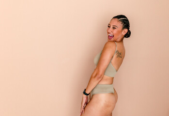 Laughing Hispanic woman models underwear