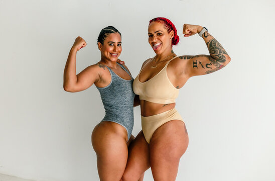 Athletic women flexing muscles