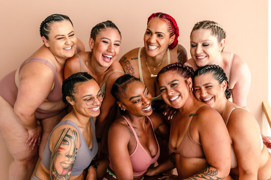 Diverse body types of laughing friends