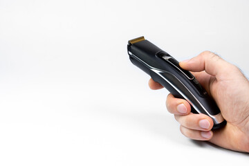 Hair clipper in hands on a white background