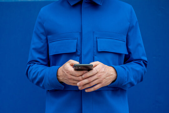 Crop man using mobile phone