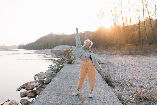 Strong Woman Dancing Near River Outdoors