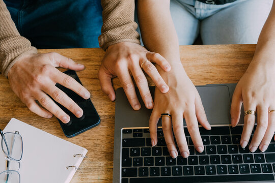 caressing hands of a couple while they work