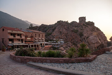 Coast with mountains and old defensive tower on Corsica island (city Porto, Corsica, France)