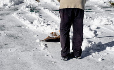 Man removing snow with a shovel