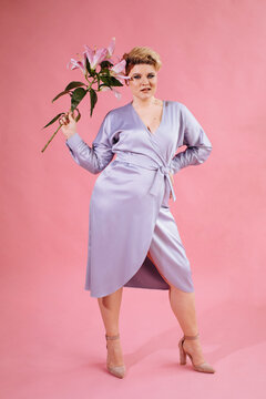 Trendy curvy woman in lavender dress with flowers